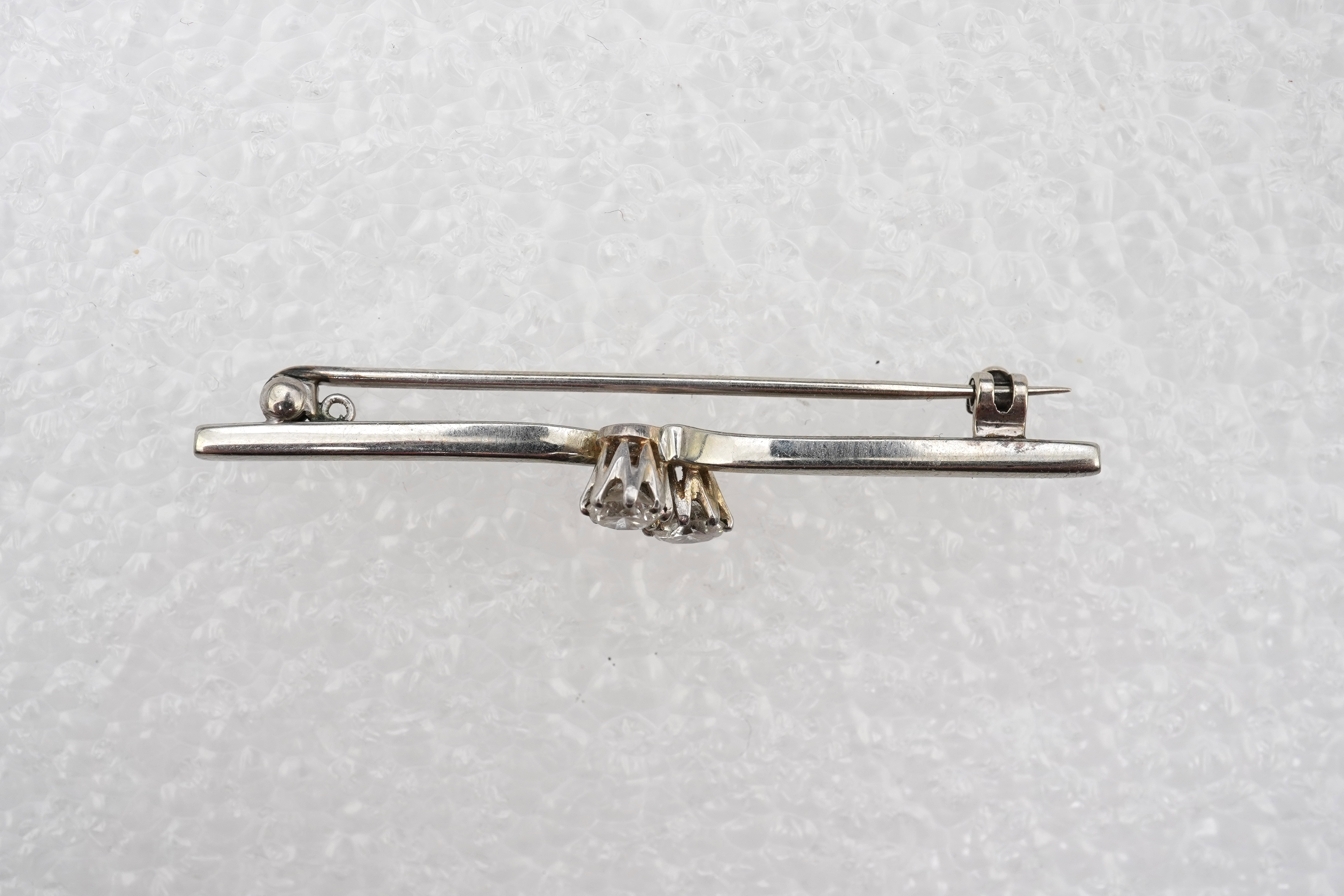 A diamond bar brooch